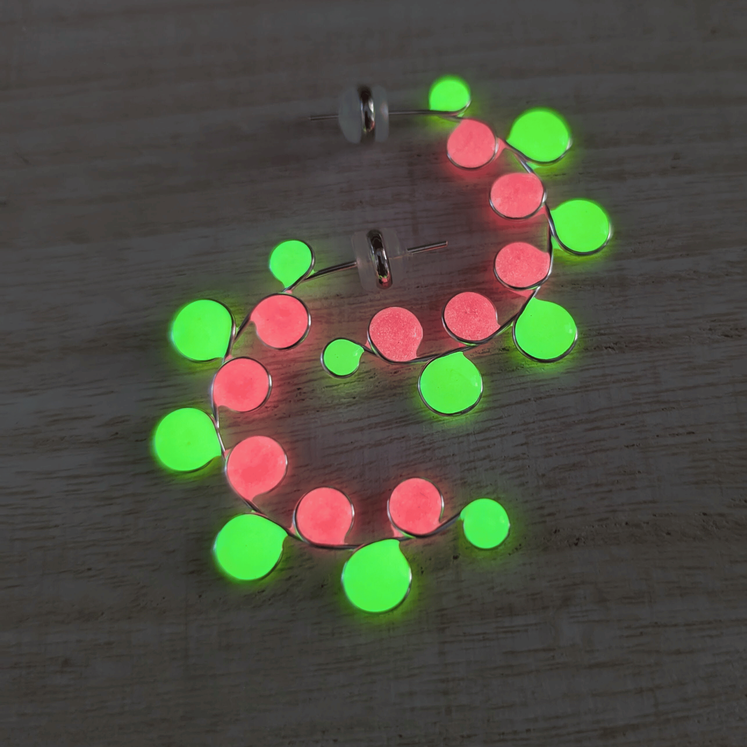 Neon colored pink and yellow glow in the dark hoop earrings