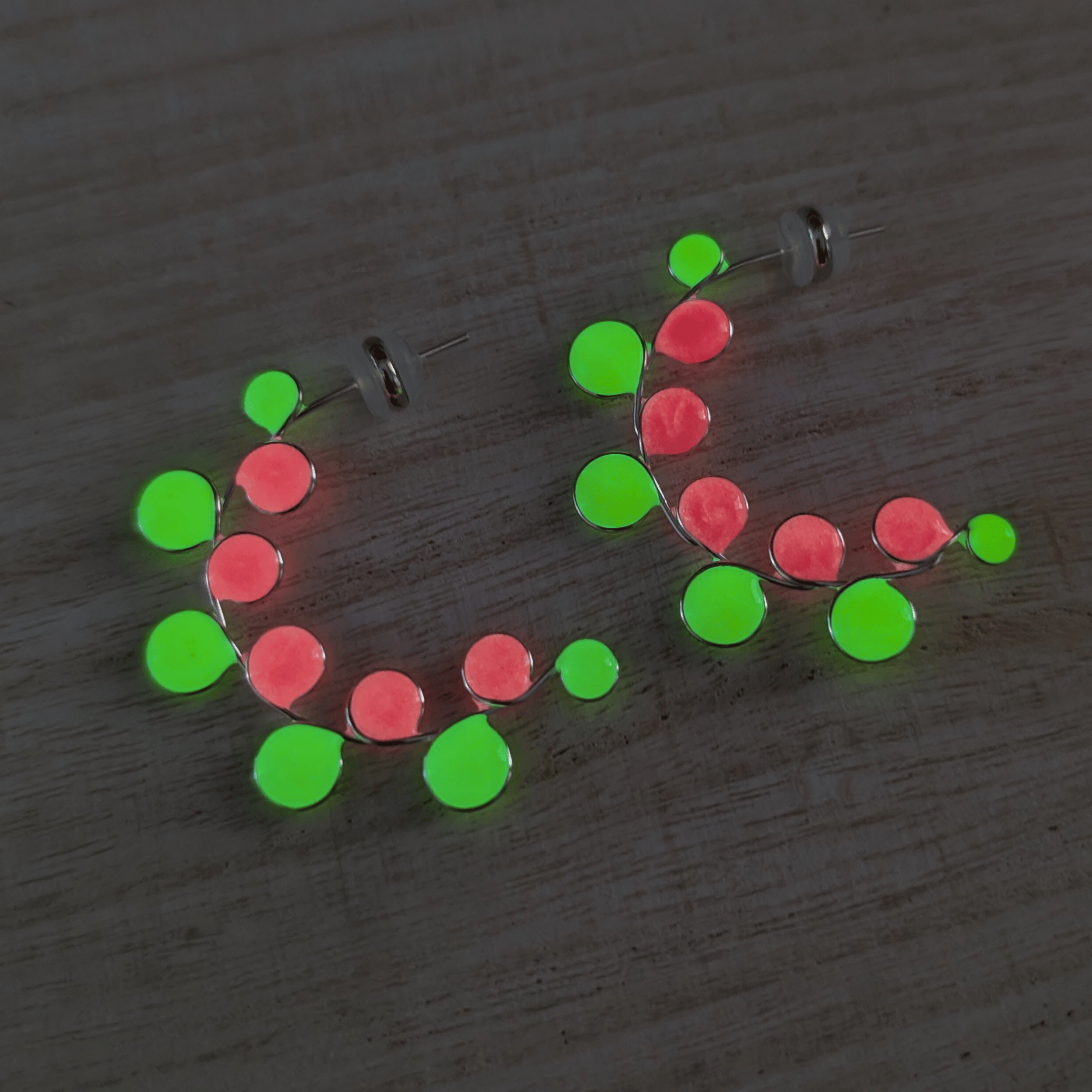 Neon colored pink and yellow glow in the dark hoop earrings