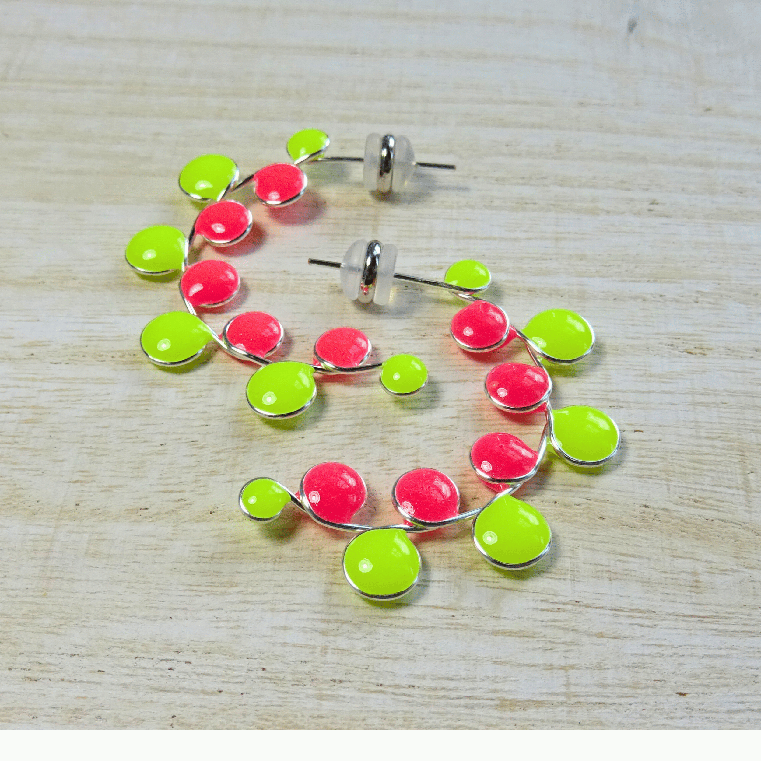 Neon colored pink and yellow glow in the dark hoop earrings