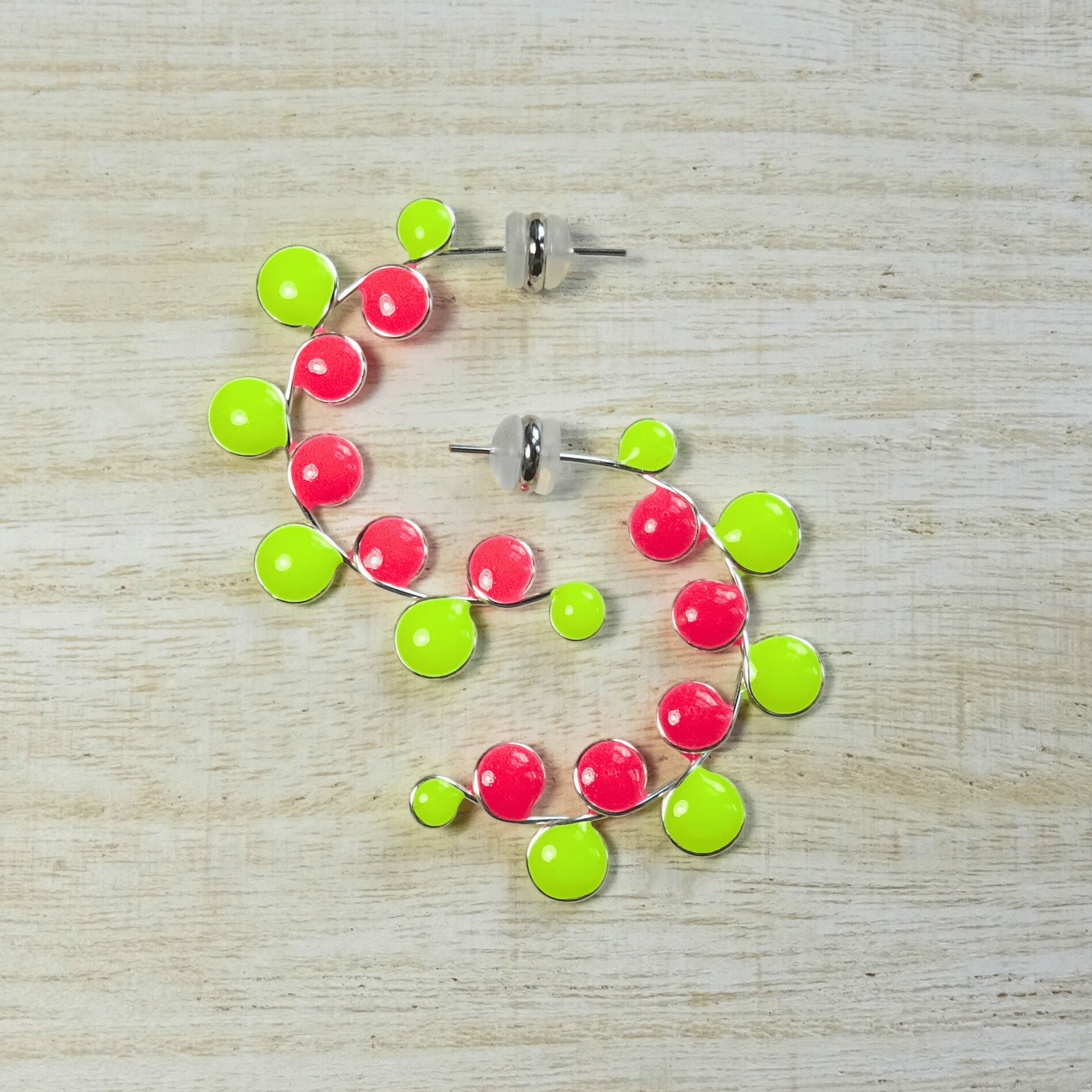 Neon colored pink and yellow glow in the dark hoop earrings