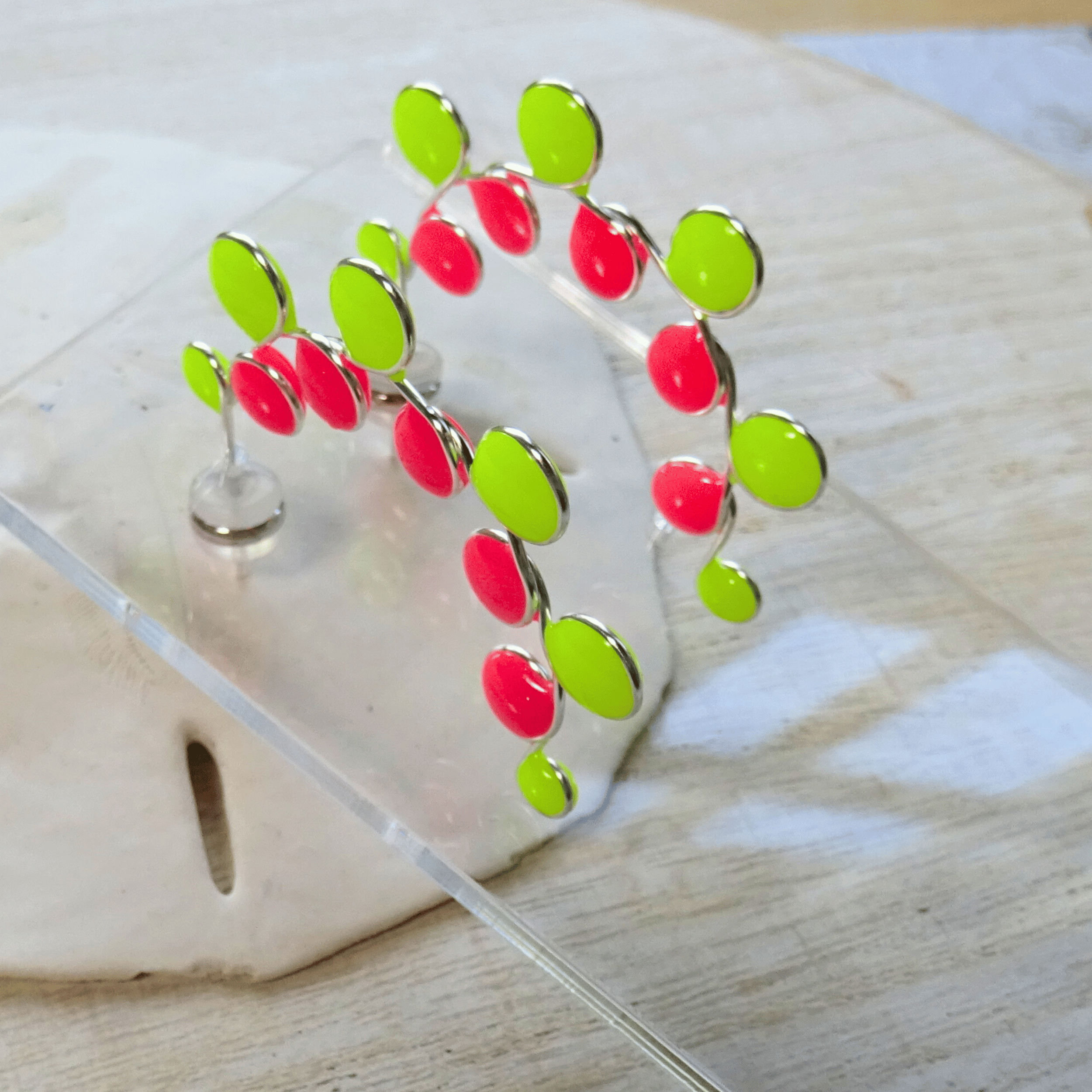 Neon colored pink and yellow glow in the dark hoop earrings