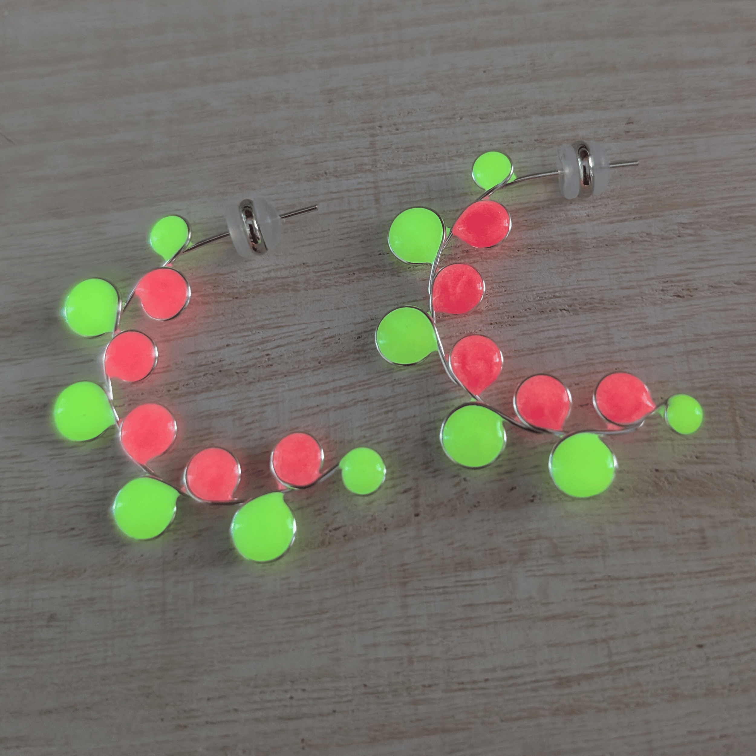Neon colored pink and yellow glow in the dark hoop earrings